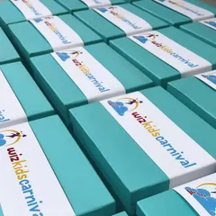Gifting with style. These custom-curated hampers for Wizkids Carnival feature vibrant branded sleeves over turquoise boxes, creating a fun and professional look.
