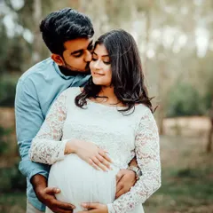 So adorable together. An outdoor setting provides a beautiful, natural backdrop for capturing sweet moments like this kiss on the cheek.