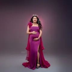 This full-length portrait showcases the elegant silhouette of the magenta gown against a softly lit backdrop. My focus is on creating a balanced and artistic composition.