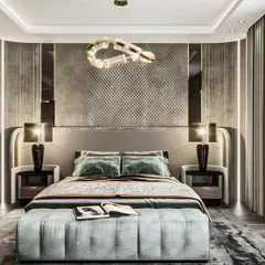 This luxurious bedroom features a textured, quilted accent wall and elegant high-arc bedside lamps. The tufted bench and sophisticated color palette of grey and muted teal create a hotel-like sense of comfort and style.