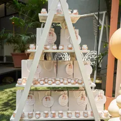 A stylish A-frame shelf displaying party favors for a boho-themed birthday. The display is both functional and a beautiful part of the overall event decor.