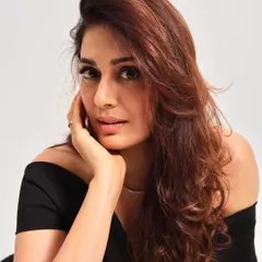 A close-up of the soft glam look, showing the flawless skin finish, subtle contour, and the soft waves of the blowout hairstyle.