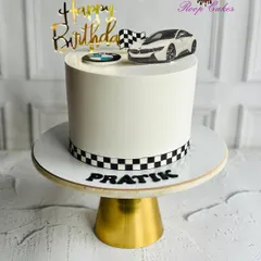 Start your birthday in high gear. A sleek BMW-themed cake for a car enthusiast, complete with a checkered racing stripe and luxury vibes.