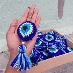 A close-up look at my bestselling evil eye keychain, complete with a handmade tassel. These are popular for personal use and as unique return gifts for parties and events.