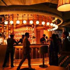 Capturing the lively atmosphere at the Comorin bar. This image shows the space in action, with staff and patrons creating a dynamic and energetic scene that feels authentic and inviting.