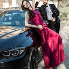 Confidence and style take center stage in this shot featuring a luxury car. The bride's pose is powerful and glamorous, creating a high-fashion image that is both bold and romantic.