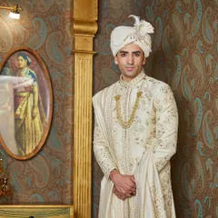 A profile view highlighting the handcrafted turban and the texture of the silk fabric. The understated elegance of this ensemble is perfect for a sophisticated daytime wedding.