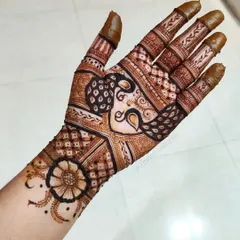 A full-palm design showcasing a beautiful peacock motif integrated with traditional Indian patterns. The detail work on the fingers and wrist completes the look.