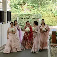 The bride and her squad walking together, sharing a laugh. A candid, happy moment that captures the easy bond of friendship.