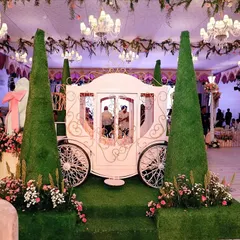 A fairytale entrance fit for a princess. I designed this life-sized royal carriage, framed by manicured topiary, to create an unforgettable photo moment and set the stage for a magical celebration.