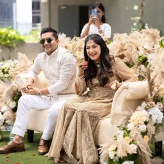 A candid moment of laughter and joy. The makeup is designed to look natural and radiant in outdoor lighting.