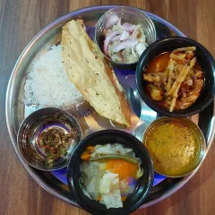 Our special Naga Thali, a complete meal that brings the authentic taste of Nagaland to your plate. It includes rice, dal, boiled vegetables, eromba or another traditional side, and a Naga-style chicken curry with bamboo shoot.