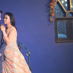 A romantic shot of a couple during their pre-wedding shoot. The client wears the elegant peach gown, demonstrating its versatility for photoshoots and formal occasions.