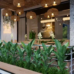 From this angle, you can see the seamless flow from the outdoor planters to the interior greenery. We used plants to blur the lines between inside and out, creating a refreshing and cohesive eco-friendly cafe design.