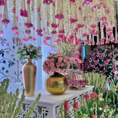 An enchanting bloomscape designed to captivate. We layered draped florals, elegant golden vases, and a symphony of pinks to create a corner filled with pure, celebratory magic.