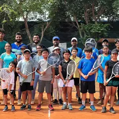 The Tennis Vidyalaya family. A group photo of our players and coaches on the court, fostering a sense of team and community that is vital for growth and support.