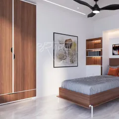 This bedroom is designed for simplicity and function. The wooden bed frame and full-height wardrobe with clean white borders provide ample storage while maintaining a light, uncluttered feel.