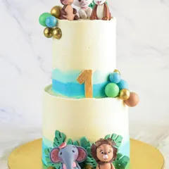 This two-tiered animal-themed cake was for baby Jaee's first birthday. It's so special to be a part of these milestones, creating something memorable for the family.