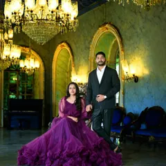 A grand and regal pre-wedding portrait. This couple chose a deep purple gown with voluminous ruffles, which looks stunning in this palace-like setting with crystal chandeliers.