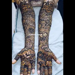 A beautiful example of a heavy floral bridal design. The arms are covered in a tapestry of roses and leaves, creating a rich and luxurious look for the bride.