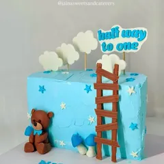 Celebrating a big milestone: halfway to one. This adorable 6-month birthday cake is designed with a cute teddy bear, fondant clouds, and a ladder, symbolizing the climb to the first birthday.