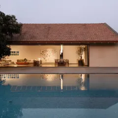 The pool at our Alibaug holiday home, designed to reflect the clean lines of the architecture. The living space opens directly onto the pool deck, completely erasing the line between the interior and the serene outdoor environment.