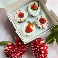 A box of our special Valentine's Day cupcakes. These strawberry and cream cupcakes are topped with fresh fruit and heart decorations, making them a sweet gift for your loved one.