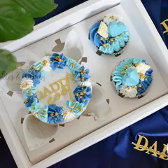 A special gift box for Dad. This combo includes a mini bento cake with a "Daddy Cool" topper and three matching cupcakes in shades of blue and white.