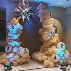 I can create decor for sensitive and meaningful events, like this setup for an awareness campaign. The design uses symbolic black ribbons on a subtle balloon arrangement to convey the message with respect and elegance.