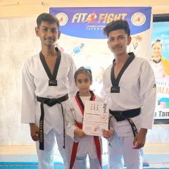 Our senior black belt coaches with a student who has just earned her certificate. We are proud to guide fighters of all ages through their progression.