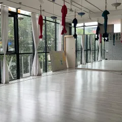 Our main aerial studio, "The Deck," is bathed in natural light, with high ceilings and professional-grade equipment. It's a safe and beautiful space for students to learn to fly.
