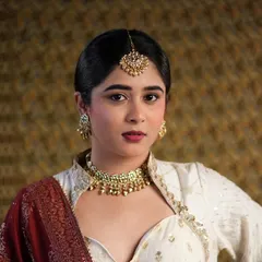 A close-up of a modern-traditional look I created for a photoshoot. I focused on a flawless matte base, a defined berry lip, and clean eye makeup to complement the intricate gold jewelry and elegant outfit.