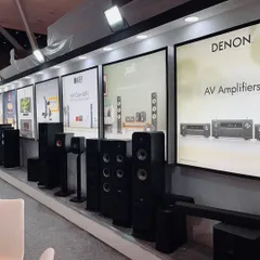Our product display wall at the Smart Home Expo, featuring a curated lineup of speakers and AV amplifiers from leading brands like KEF, Polk, and Denon. This setup allows for easy comparison and detailed discussions with clients.