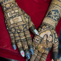 This baby shower mehendi is extra special with a portrait of the expecting parents on one hand and a "Baby Mehta Coming Soon" message on the other.