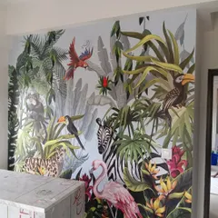 I love bringing the outdoors in with bold, tropical murals. This vibrant jungle scene, featuring a variety of animals and lush foliage, turned a plain wall into an exciting and colorful feature. It's a custom design perfect for making a statement in living rooms or creative spaces.