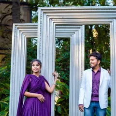 The couple posing with frames. The groom's modern and casual look is perfect for a fun photoshoot.