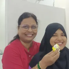 A teacher shares a piece of cake with a student. These small, personal moments of celebration define our nurturing environment.