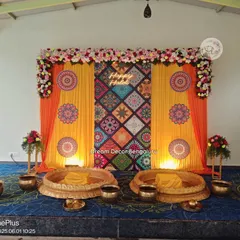 A colorful Haldi backdrop with a patterned fabric centerpiece and a neon "Happy Haldi" sign. The traditional brass urlis for the ceremony complete the look. I was so happy to do this for a repeat client!