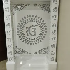 A frontal view of the 'Ek Onkar' mandir, showing the precision of the jali work on the pillars and back panel.