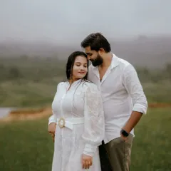 A gentle, intimate portrait taken during a misty morning shoot. The soft light and foggy background create a serene and romantic setting, focusing purely on the couple's connection.