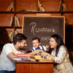 Learning is a family affair. I love capturing candid interactions, like this moment of shared laughter during a creative "little scholar" themed family photoshoot.