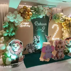 Another angle of the safari-themed birthday party, showing the full arrangement of the animal cutouts and the impressive balloon garland that frames the personalized backdrop.
