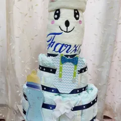 How cute is this diaper tower for a new baby boy? It’s a creative and practical gift for a baby shower, built with diapers and topped with a cozy blanket embroidered with the baby's name.