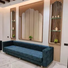 This is a long, custom-length sofa I built for a client's spacious living room. The channel-tufted back and plush blue fabric create a modern and luxurious look.