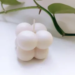 My soy wax bubble candle is a piece of decor in itself. This clean, minimalist shot shows its unique shape that brings a modern and playful touch to any space, even before it's lit.