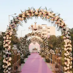 A perfect entrance for a fairytale day wedding. This grand floral archway, layered with pink and white flowers, creates an unforgettable welcome and a stunning photo opportunity.