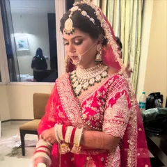A quiet moment before the ceremony. This closer view shows the detailed eye makeup and the way the jewelry is complemented by a warm, glowing skin finish.