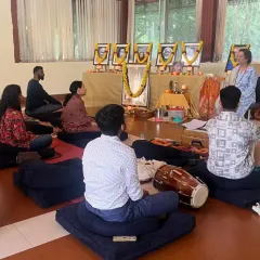 A Janmashtami celebration filled with devotion. Here, our community is in meditation after a session of kirtan, with a dholak drum resting nearby, having just filled the room with rhythmic praise for Sri Krishna.
