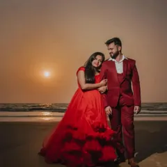 We offer coordinated looks, like this stylish three piece red suit for him that perfectly matches her red ruffled gown for a sunset beach shoot.