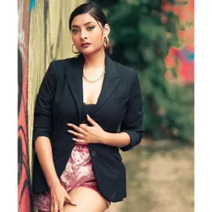 The first shot from our 'BOSS LADY' series, captured against a graffiti wall in Hauz Khas Village. The urban art adds a layer of texture and attitude to the powerful, chic styling.